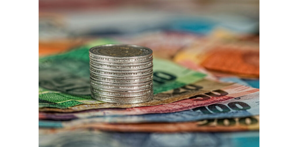 stack of coins on paper money representing financial documents needed for title pawn requirements